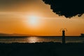 Amazing sunset seascape. Beach shower and orange sky. Brela Croatia, Makarska riviera Royalty Free Stock Photo