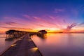 Sunset on Maldives island, luxury water villas resort and wooden pier. Beautiful sky and clouds and beach background for summer va Royalty Free Stock Photo