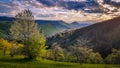 Amazing sunset. View of spring landscapes, sunlight and dark clouds above... Royalty Free Stock Photo