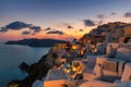 Amazing sunset view of traditional Greek houses in Oia village on Santorini island, Greece Royalty Free Stock Photo