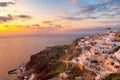 Amazing sunset view of traditional white houses in Oia village on Santorini island, Greece Royalty Free Stock Photo