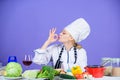 Amazing taste. Turn ingredients into delicious meal. Culinary skills. Woman chef wear hat apron near table ingredients Royalty Free Stock Photo