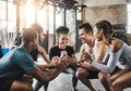 Amazing things happen when you join a gym. a group of young people doing squats together during their workout in a gym. Royalty Free Stock Photo