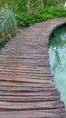 Amazing touristic wooden pathway in the colorful deep forest with clean lakes and spectacular waterfalls, Plitvice National Park, Royalty Free Stock Photo