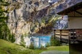 Oeschinnensee, wooden chalet and Swiss Alps, Switzerland.