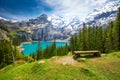 Amazing tourquise Oeschinnensee with waterfalls, wooden chalet and Swiss Alps, Berner Oberland, Switzerland Royalty Free Stock Photo