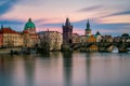 Amazing towers of Charles bridge with reflection at Vltava river during cloudy sunset, Prague, Czech republic Royalty Free Stock Photo