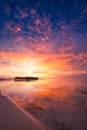 Amazing tropical beach sunrise or sunset landscape, luxury water villas and mirror reflection and colorful sky. Royalty Free Stock Photo