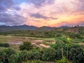 Amazing tropical landscape with field and mountain at sunset with wonderful fairytale sky