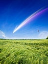 Amazing unreal image: giant bright colorful comet, rising full moon, flying hot air balloon in blue sky over green field