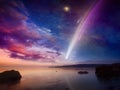 Amazing unreal picture: giant colorful comet in glowing sunset sky over calm sea. Comet is icy small Solar System body Royalty Free Stock Photo