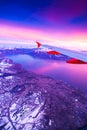 Amazing view from the airplane window during the sunset over mountains in Switzerland Royalty Free Stock Photo