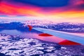 Amazing view from the airplane window during the sunset over mountains in Switzerland Royalty Free Stock Photo