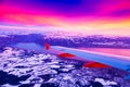 Amazing view from the airplane window during the sunset over mountains in Switzerland Royalty Free Stock Photo