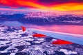 Amazing view from the airplane window during the sunset over mountains in Switzerland Royalty Free Stock Photo