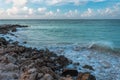 Amazing view of Aruba coast line. Turquoise water of Atlantic ocean merging with blue sky with white clouds. Royalty Free Stock Photo