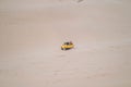 Amazing view of big car driving on sandy dunes and tire tracks on sand. Royalty Free Stock Photo