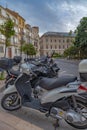 Amazing view of the city parking for scooters on Paseo Del Parque in Malaga. Close up photo on lots of parked assorted scooters.