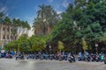 Amazing view of the city parking for scooters on Paseo Del Parque in Malaga. Close up photo on lots of parked assorted scooters.