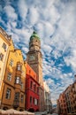 Amazing view of City Tower over the traditional colourful houses against picturesque sky. Old town of Innsbruck, Austria