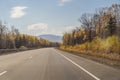 Amazing view with colorful autumn forest with asphalt mountain road. Beautiful landscape with empty road, trees and Royalty Free Stock Photo