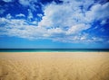 Amazing view of the emerald sea, yellow sand and blue sky with clouds, spring Royalty Free Stock Photo