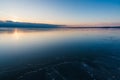 Amazing view of the frozen lake at sunset. Delightful evening landscape. Royalty Free Stock Photo