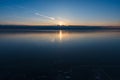 Amazing view of the frozen lake at sunset. Delightful evening landscape. Royalty Free Stock Photo