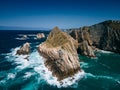 amazing view of grassy rocky cliffs by the cantabrian sea with violent waves, asturias, spain
