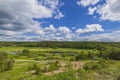 Amazing view of green summer landscape with  river against blue sky and white clouds. Royalty Free Stock Photo