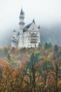 Amazing view of Neuschwanstein castle in autumn season at fog. Bavaria. Germany. Neuschwanstein castle one of the most popular pal Royalty Free Stock Photo