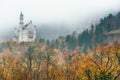 Amazing view of Neuschwanstein castle in autumn season at fog. Bavaria. Germany. Neuschwanstein castle one of the most popular pal