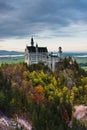 Amazing view of Neuschwanstein castle in autumn season at sunset. Bavaria, Germany. Neuschwanstein castle one of the most popular Royalty Free Stock Photo