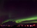 Amazing View of the Northern Lights Swirling over a Small Town of Reykjahlid in Northern Iceland
