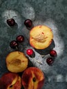 Amazing view of peaches and cherries on the table. Bright, juicy fruits - peaches and cherries