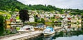 Amazing view of the pier with boats in Norheimsund near Steinsdalsfossen. Location: Norheimsund, Hardangerfjord, Norway.