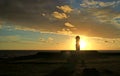 Amazing view of the setting sun shining through the silhouette of Moai statue of Ahu Ko Te Riku, Tahai , Easter Island, Chile