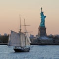 Amazing view of the Statue of Liberty and sailboat, at sunset Royalty Free Stock Photo