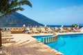 Amazing view on swimming pool area and sunbeds under palm tree w Royalty Free Stock Photo