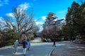 Amazing View to the Japanese Castle via trees under Blue Cloudy Sky