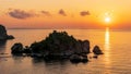 amazing view to a sunrise or sunset above beautiful isle in sea with nice coasline and clouds on the background of the evening sea