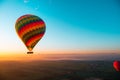 Amazing view of a vibrant colorful balloon at sunrise, flame firing to propel the balloon upwards. Balloon ride at luxor, egypt,