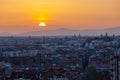 An amazing warm sunset over the skyline of Madrid and Sierra de Guadarrama from the Tio Pio parque