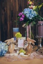 An amazing wedding bouquet in blue violet tones with the candles beautiful rustic wood vintage decoration for event