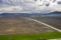 beautiful green countryside, fields, road, and cloudy sky Royalty Free Stock Photo