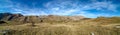 Amazing wide horizontal panorama of mountain range landscape during beautiful blue sky day in the autumn as panoramic view of