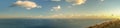 Amazing wide panoramic mountain view with the nice sky and the sea in the warm sun light in afternoon Royalty Free Stock Photo