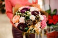 Amazing winter bouquet of gorgeous flowers in woman hands