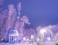 Amazing winter landscape in evening park. Gazebo, lantern lights Royalty Free Stock Photo