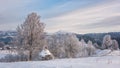 Amazing winter landscape with frozen trees, snow, mountain and blue sky with clouds, rural scene, outdoor travel background Royalty Free Stock Photo